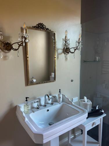 a bathroom with a white sink and a mirror at Convent at Koroit in Koroit
