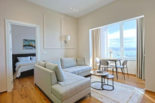 a living room with a couch and a table at Lux Holidays 221 in Durrës