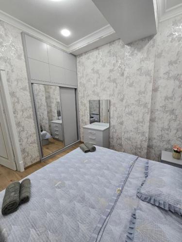 a bedroom with a large bed and a mirror at Conveniently located near the Tashkent City area, close to the city center in Tashkent