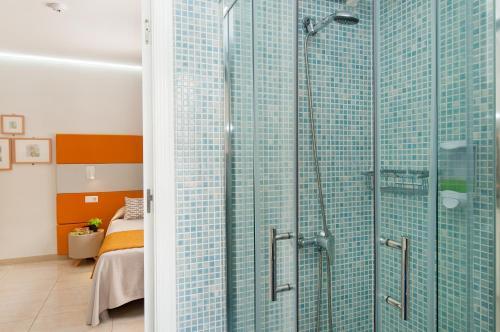 a bathroom with a shower with blue glass at Hotel Apartamento Bajamar in Las Palmas de Gran Canaria