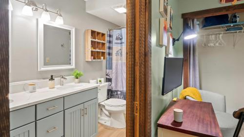 a bathroom with a sink and a toilet and a tv at Boulder Pointe by AvantStay Deck Forest Views Boulder Lake Club Passes in Lake Harmony