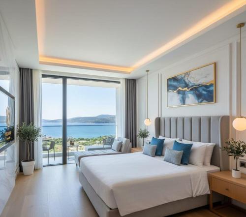 a bedroom with a large bed and a large window at THE PERLA Bodrum HOTEL in Bodrum City