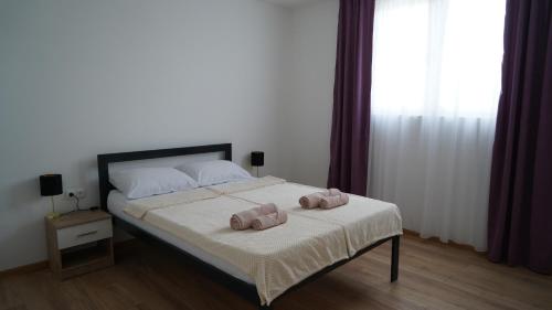 a bedroom with a bed with two towels on it at Sun&Silence in Mostar