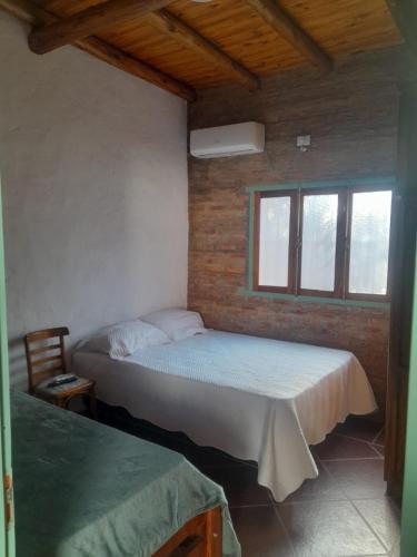 a bedroom with two beds and a window at Alojamiento Madariaga 224 in Goya