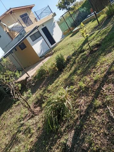 a house sitting on top of a grassy hill at Rosa Ignea in Valle Hermoso