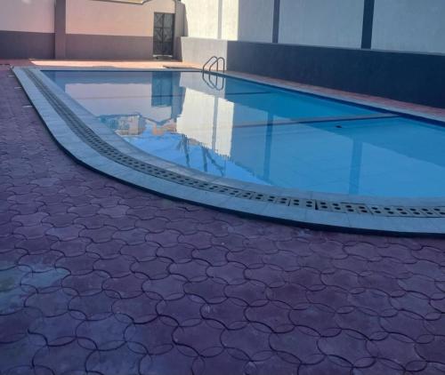 a swimming pool with a ramp in a building at The Residence Beach Apt Nyali in Mombasa