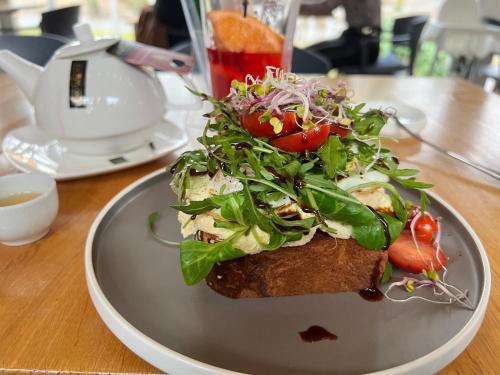 a plate of food with a salad on a table at Old Town Square Szczecin in Szczecin