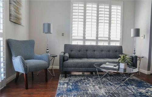a living room with a couch and a table and a chair at One Bedroom Condo with Ocean and Marina Views in Long Beach