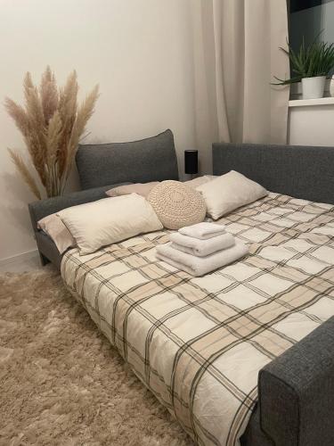 a bed with two pillows and a blanket on it at Bývaj u Mari v mestskom parku s bezplatným parkovaním in Piešťany