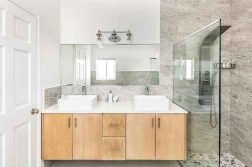 a bathroom with two sinks and a shower at New Unique Villa Blue Top! 2 Bedroom Waterfront in Providenciales