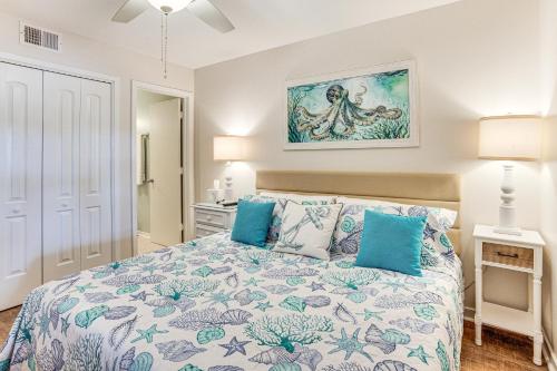 a bedroom with a large bed with blue pillows at Poolside Fun & Ocean Strolls: Harbor Island Haven! in Fripp Island