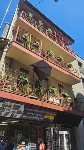 a building with a balcony with potted plants on it at Holiday Apartments Walter in Interlaken