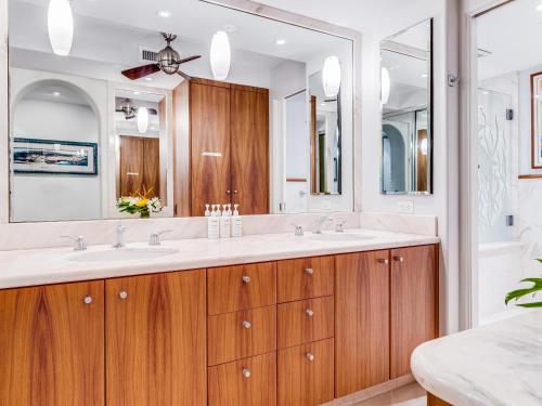 a bathroom with two sinks and a large mirror at Polo Beach Club 301 in Wailea