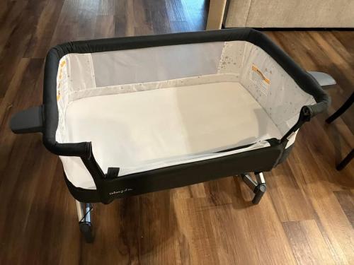 a black and white baby cart on a wooden floor at Historic bungalow on Church Street in Georgetown
