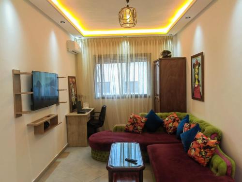 a living room with a couch and a tv at Mydar Airport in Tangier