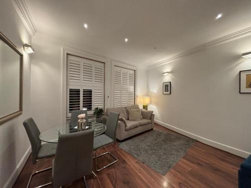 a living room with a couch and a table at Discover London Central 2 Bedroom in Kensington in London