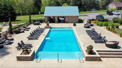 a large swimming pool with chairs and a building at Tim Ford Lake House in Twin Creeks TN in Winchester