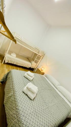 a bed in a room with two towels on it at Villa Estrella in Dos Hermanas
