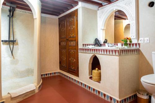 a bathroom with a sink and a toilet at Dar Alhambra Riad Medina in Marrakech