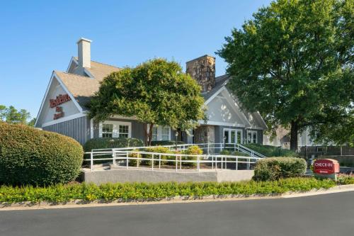 a large white house with trees and bushes at Residence Inn by Marriott Atlanta Cumberland/Galleria in Atlanta