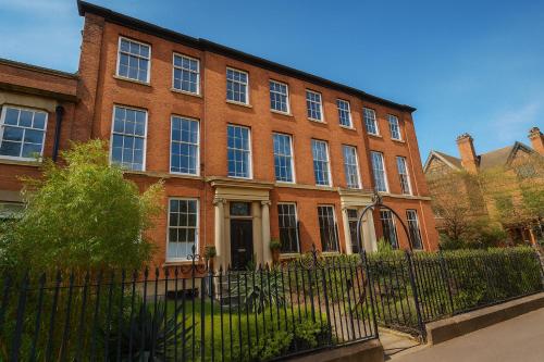 a brick building with a fence in front of it at Manchesters Ultimate House - Hot tub - Sleeps 22! in Manchester
