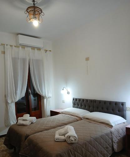 a bedroom with a large bed with towels on it at Hotel Torre in Vulcano