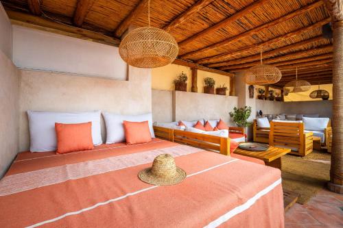 a bedroom with a bed and a living room at Dar Alhambra Riad Medina in Marrakech