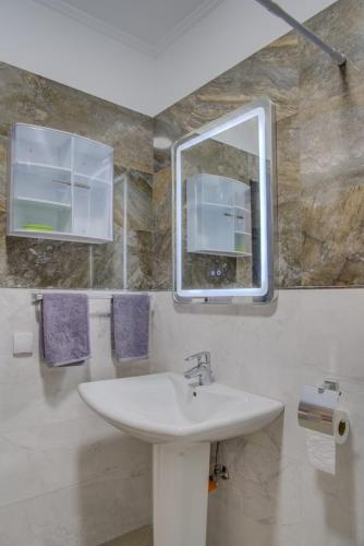 a bathroom with a sink and a mirror at jaws wave agadir 2 in Agadir