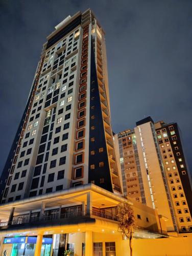 a tall building with lights on in a city at Golden Oasis at Itowers in Gaborone