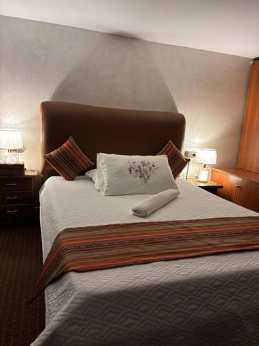 a bed in a hotel room with a pillow on it at بيت الطبيعة nature house in Jerash