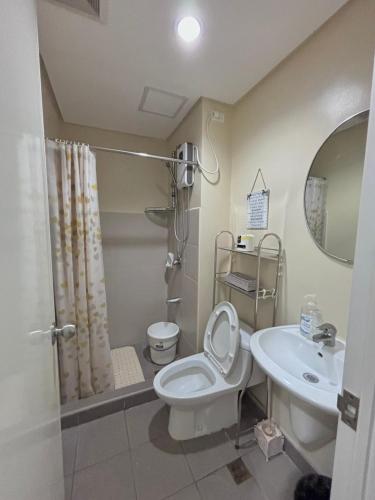 a bathroom with a toilet and a sink at New Centrio Tower Lovely Studio adj Ayala CDO in Cagayan de Oro