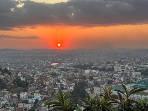 a view of a city at sunset at Golden Sunset - Appart'Hôtel in Antananarivo