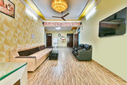 a living room with a couch and a ceiling fan at Hotel O Awirank in Patna