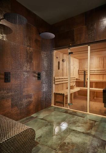 a room with wooden walls and a large mirror at Craig y Don in Llandegfan