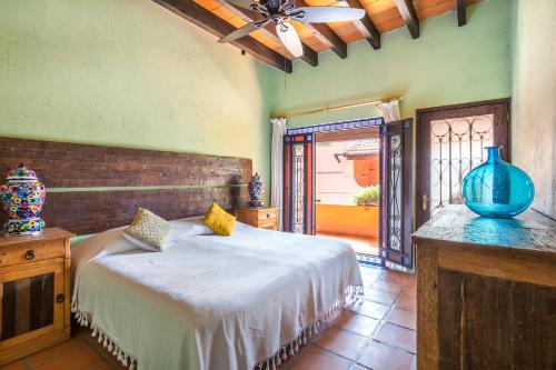 a bedroom with a bed with a vase on a table at Casona de Elefantes in Cuernavaca
