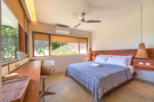 une chambre avec un lit et une grande fenêtre dans l'établissement Bayay Tamsi, à General Luna