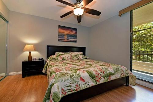 a bedroom with a bed and a ceiling fan at Paki Maui 207 · PM 207 BeachFront 1BD w Ocean View in Kahana