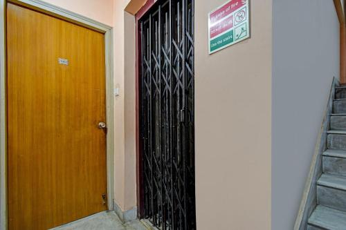 a black door with a sign on the side of a building at Hotel O Sai City inn in Jādabpur