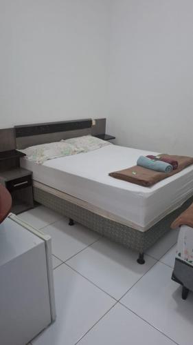 Una cama o camas en una habitación de Pousadinha Litoral