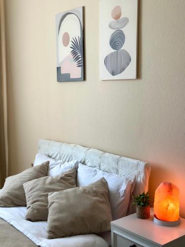 a white couch with pillows in a living room at Cozy studio with a balcony and sea view in Batumi