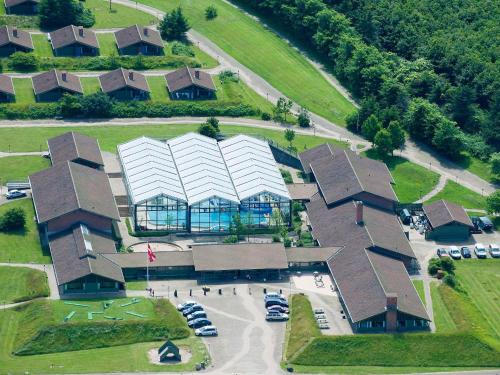 an overhead view of a building with cars in a parking lot at Room in Vigsø Holiday Park in Hanstholm