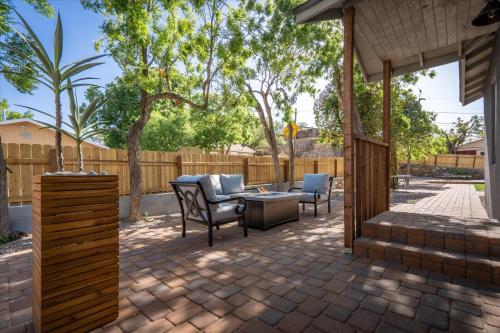 a patio with a table and chairs and a fence at Old Town Stunner in Cottonwood