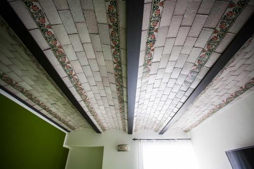 a room with a ceiling with tiles on it at Palazzo Pagliaro in Santo Stefano di Camastra
