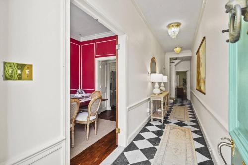 a hallway with a dining room with red walls at The Verdigris| 1800s Charm| King St| Easy Parking in Alexandria