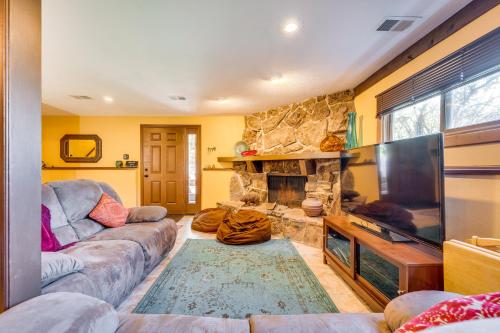a living room with a couch and a fireplace at Peaceful Mountain Retreat with View, Near Boulder! in Boulder
