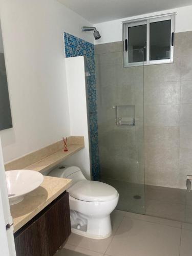 a bathroom with a toilet and a glass shower at Luxury Ocean View - Bocagrande in Cartagena de Indias