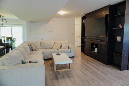 a living room with a couch and a table at Entire 3 bedroom townhouse in Cambridge
