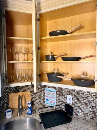 a kitchen with a sink and some pots and pans at BP STAYS - Hotel-Style, No Host, Professionally Managed ID247 in Jersey City
