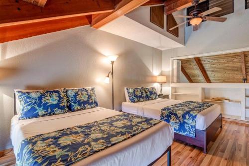 a bedroom with two beds and a ceiling at Kihei Resort 202 · KRS 202 Family Getaway 2BD w AC Pool Beach in Kihei