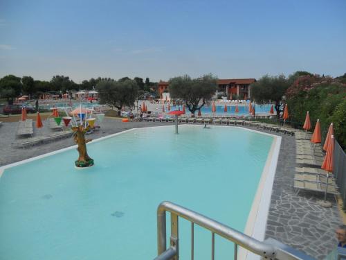 a large swimming pool in a resort at The Garda Village in Sirmione